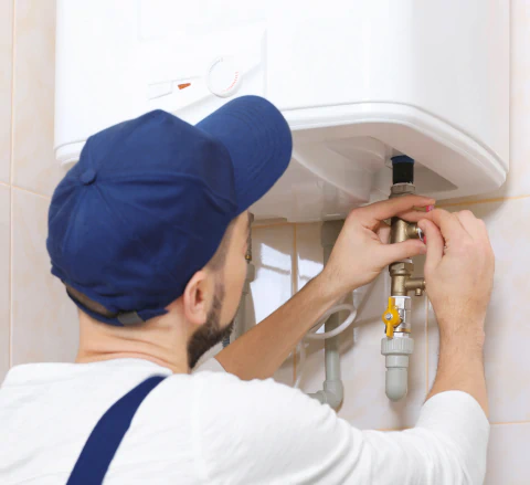 worker installing water heater